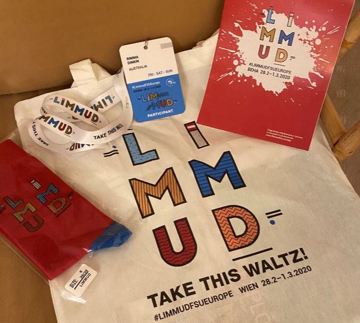 Limmud FSU merchandise flat lay including shirt, program and label